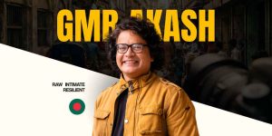Renowned Bangladeshi photographer GMB Akash featured in the TINDS "Own The Story" campaign, looking confident with a camera in hand, overlaid with abstract digital storytelling graphics